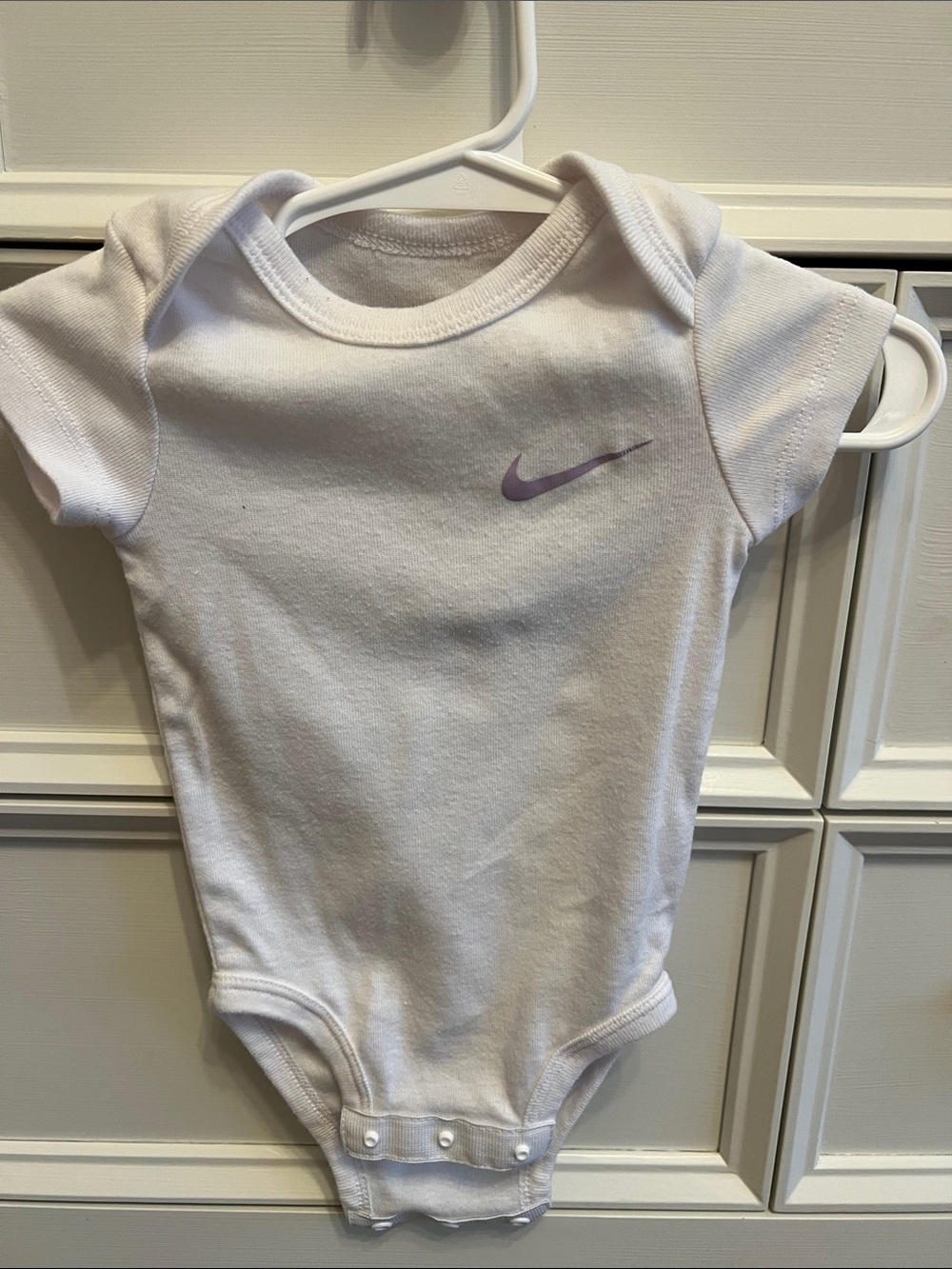 Nike White Baby Onesie with Lavender Swoosh - Kids One Piece